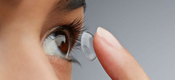 Close-up of woman putting in contact lens