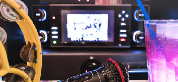 Black microphone in karaoke club, with remote controller, melon