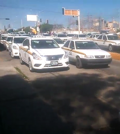 Taxistas bloquean la salida a la carretera a Guadalajara; detienen a 2 vehículos